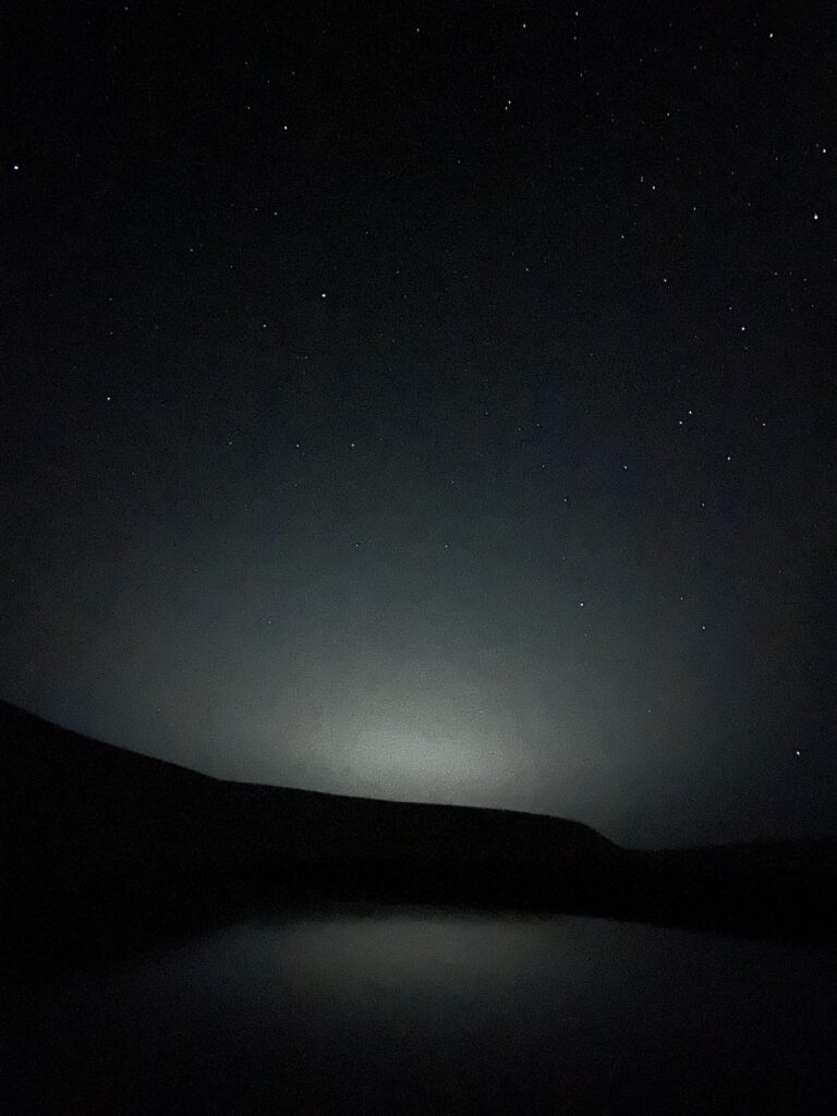 Lençois Maranhenses at night with Barreirinhas light Pollution