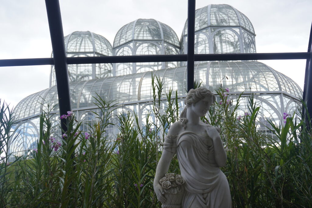 An indoor greek-style sculpture and garden in front of Curitiba's greenhouse.