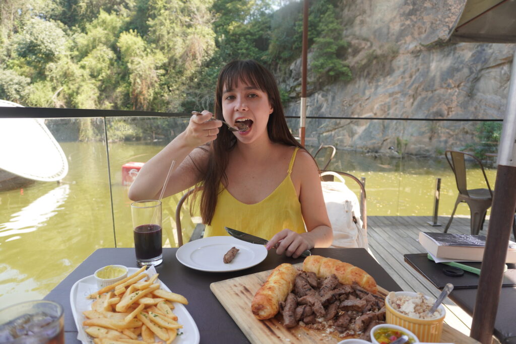 Lo Lee eating steak, fries, and garlic bread ar the Opera Arte restaurante.