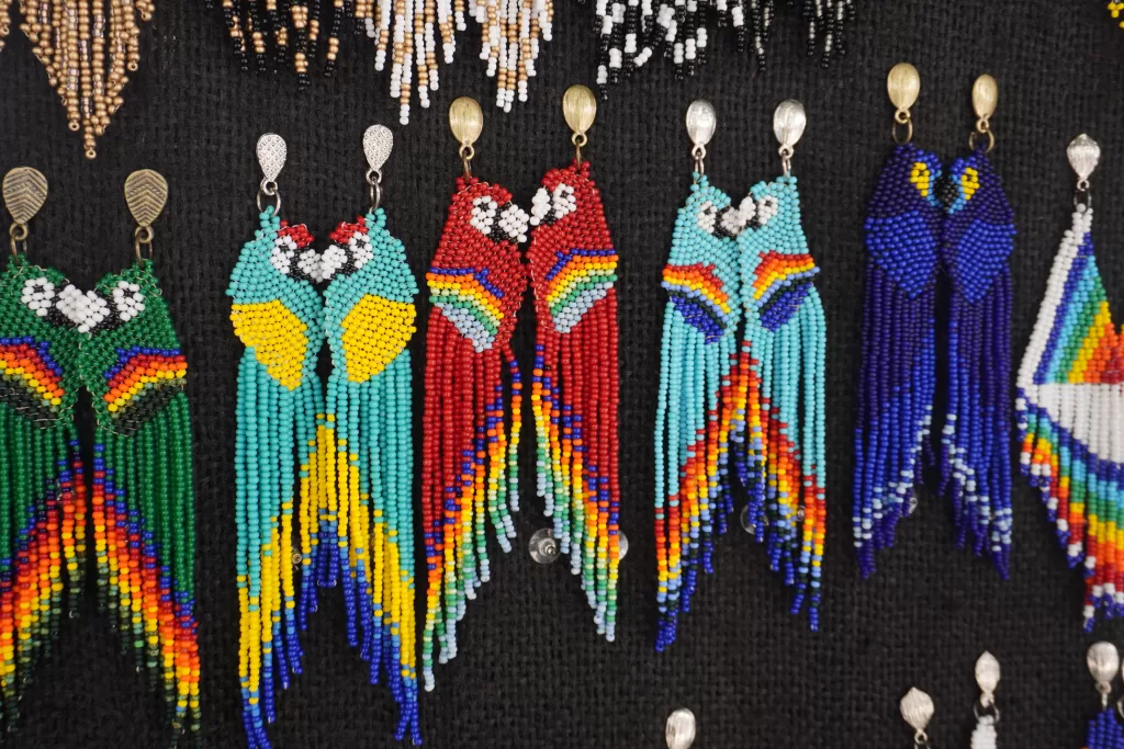 Flat macaw earrings made out of colorful beads. Macaws are available in turquoise, red, light blue, and dark blue.