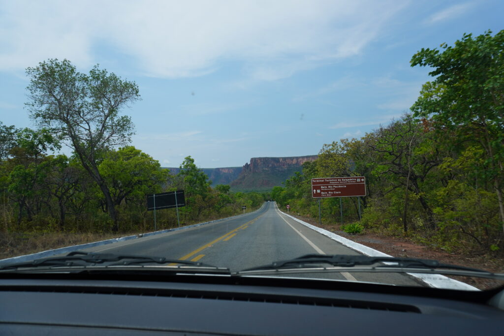 Road leading to Chapada dos Guimaraes, rock formations can be seen in the horizon