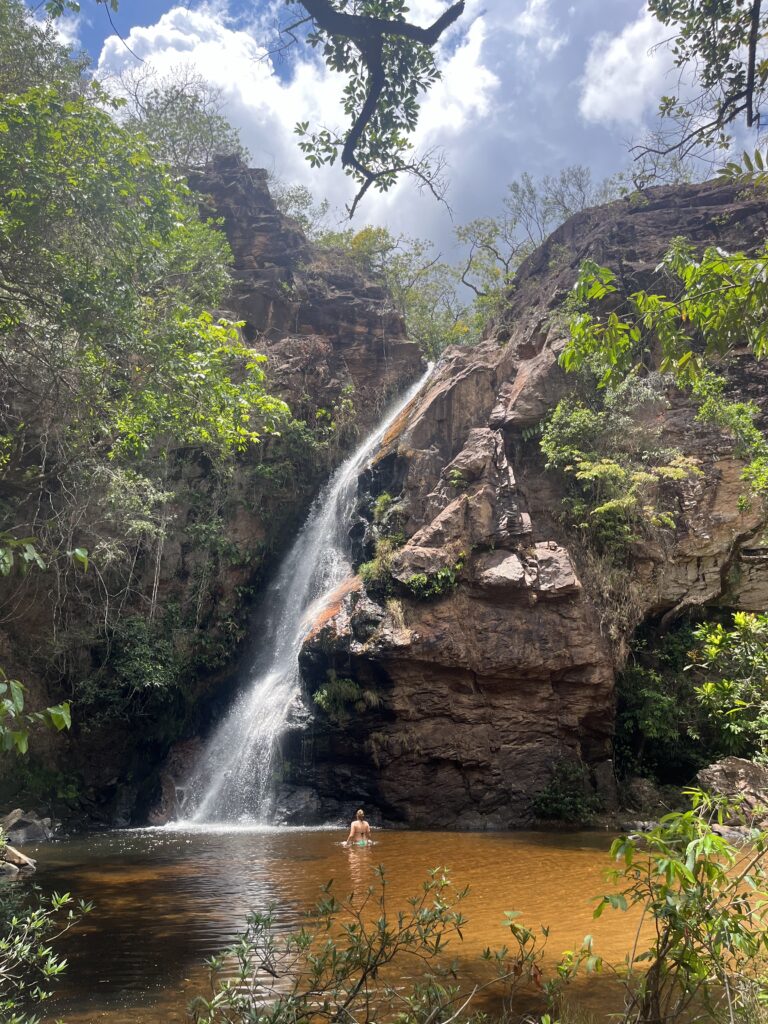 Girl swimming inside the Cachoeira das Andorinhas, which is the tallest waterfall in the Circuito das Cachoeiras at Chapada dos Guimaraes