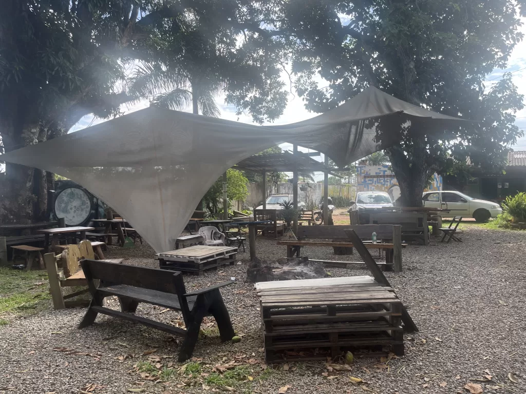 Outdoor patio of Chapada Hostel Pub with lots of rustic-style seating spaces