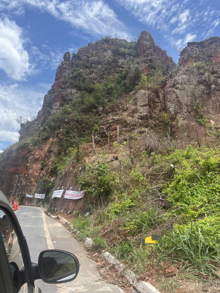 Section of the road leading to Chapada dos Guimaraes where buses and vans are not allowed. Protestor's signs are seen installed on a rock formation on the side of the road.