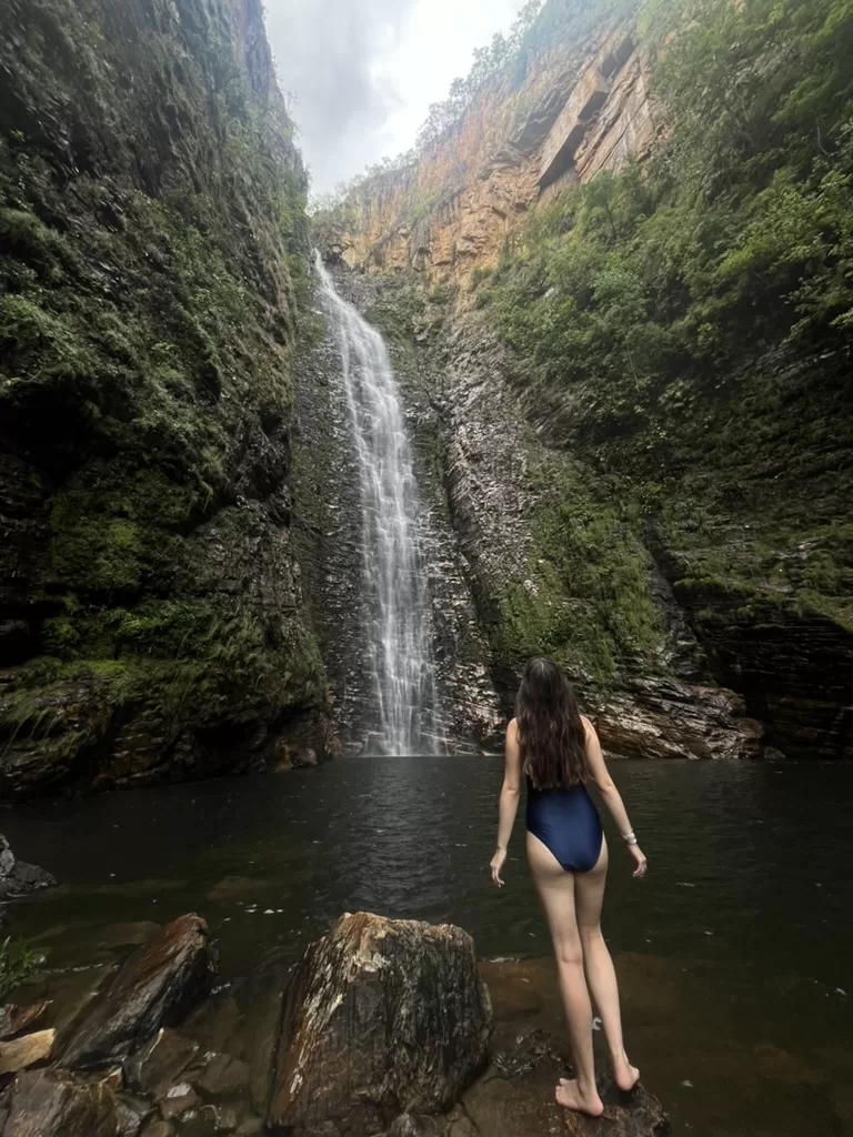 Girl standing in front of the Cachoeira do Segredo in a swimsuit