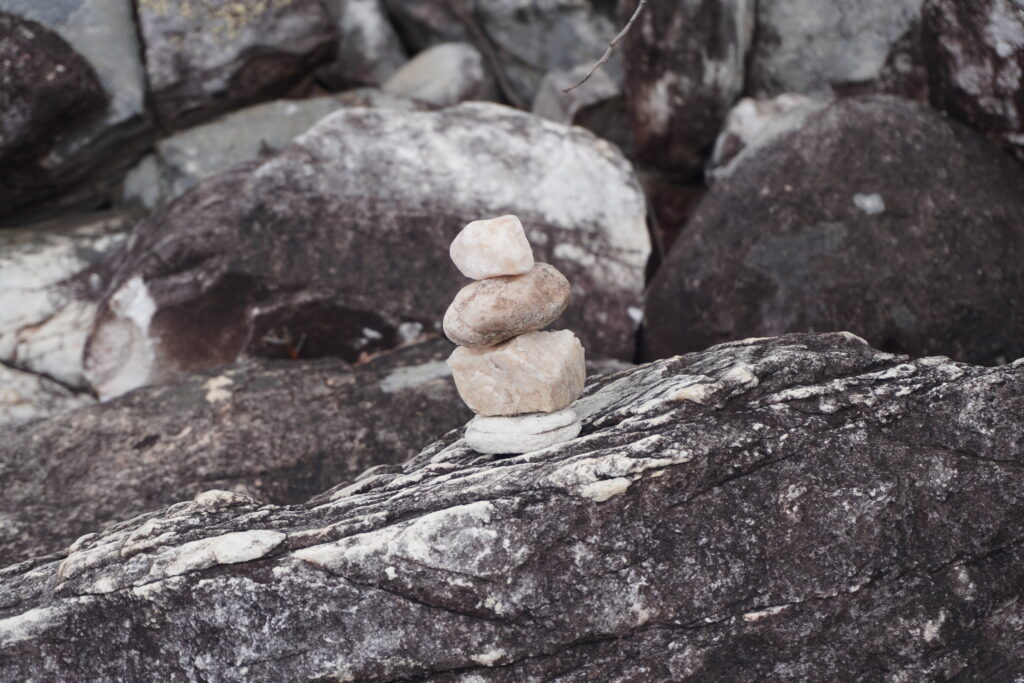 Four small quartz stones piled on top of each other.