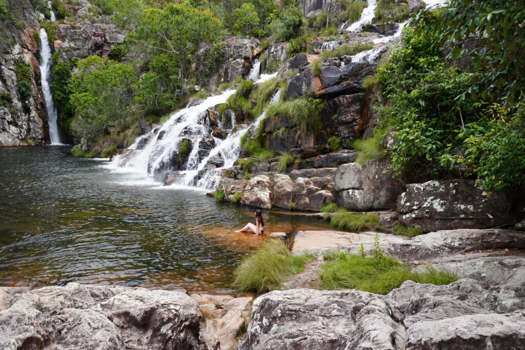 Girl sitting inside the water at the stunning Capivara waterfall