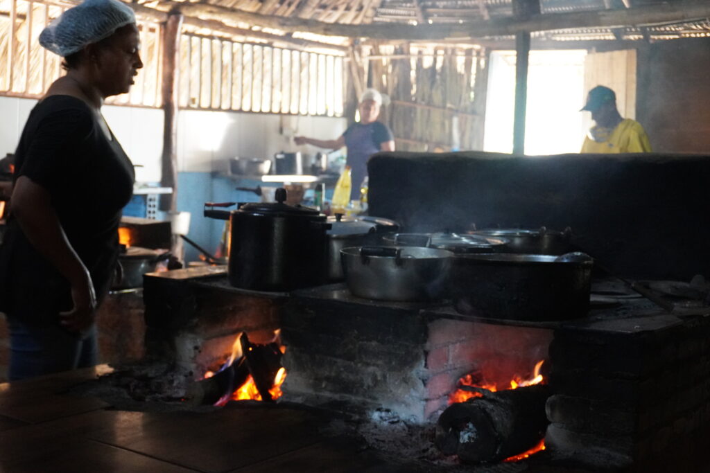 Local women cooking a meal in wood-burn stoves