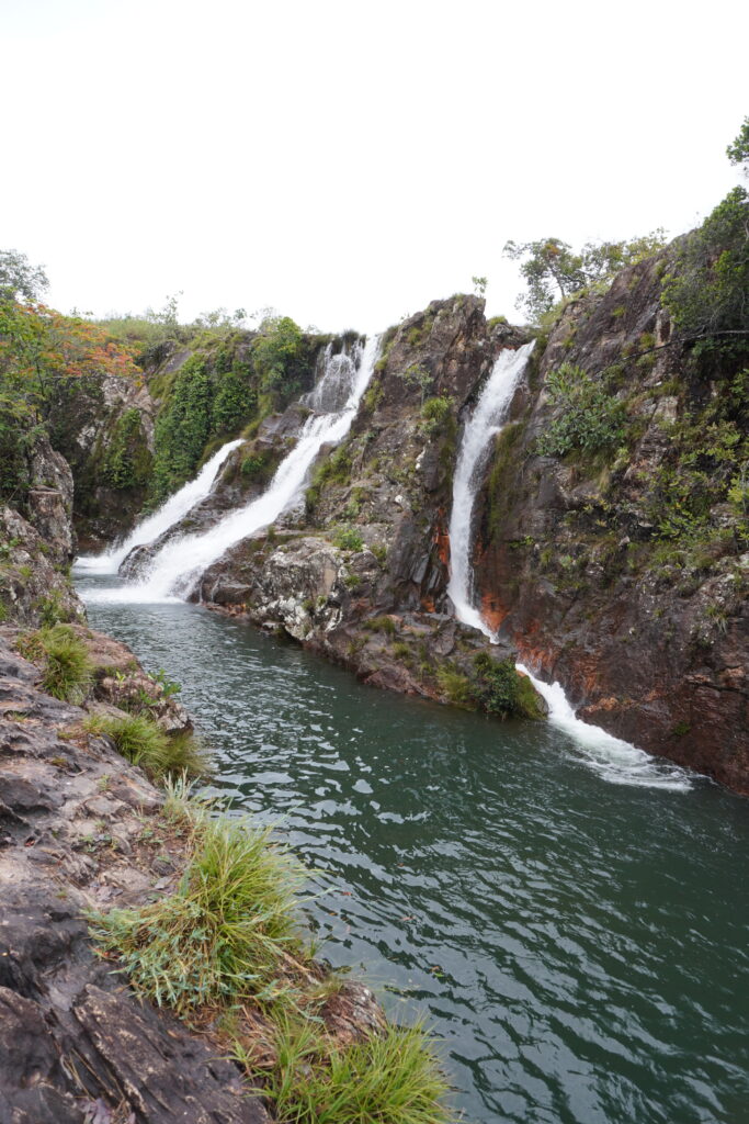 Three waterfalls falling into emerald-green pools