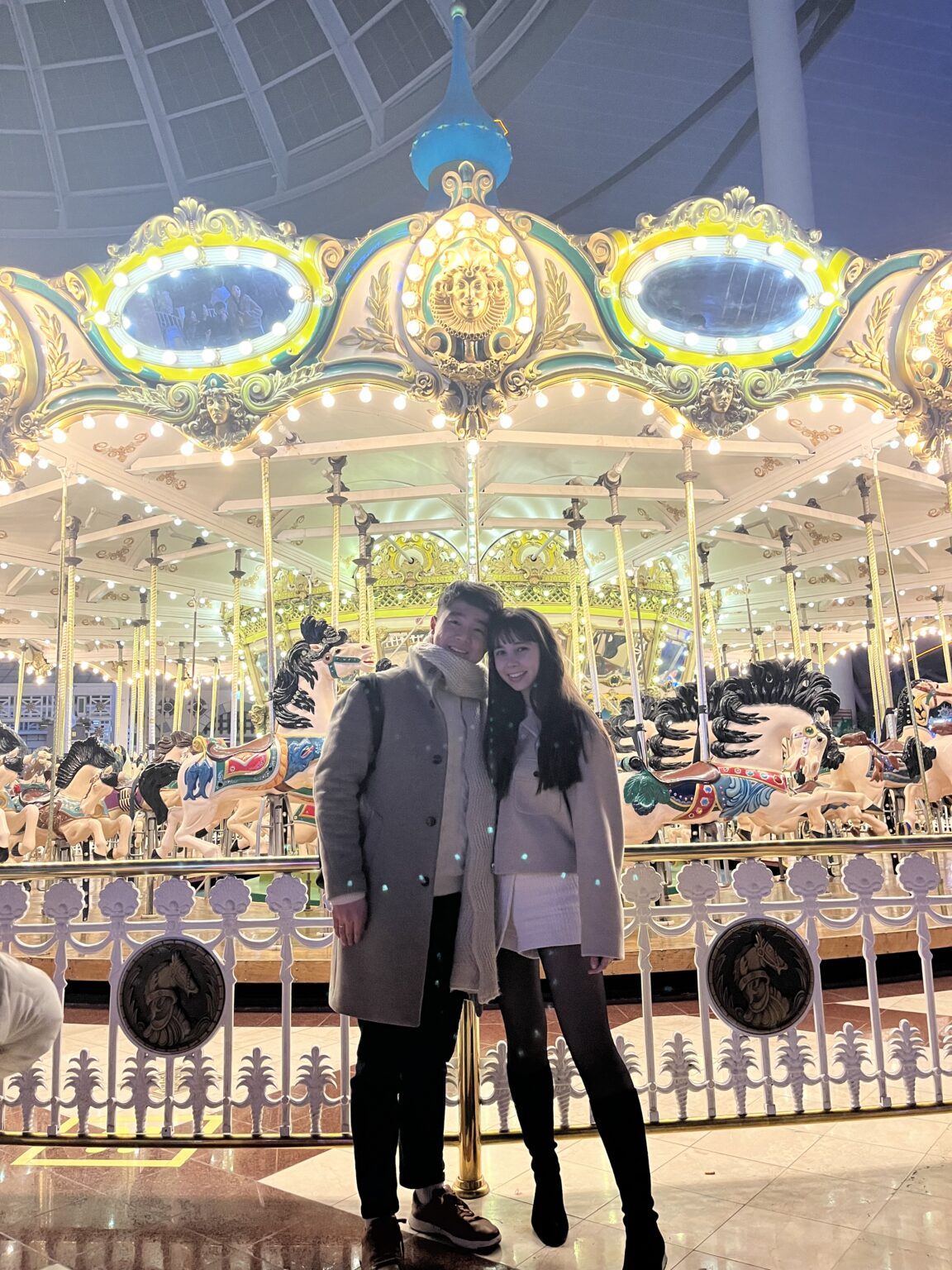 Woman and Man standing in front of the Carousel at Lotte World in Seoul