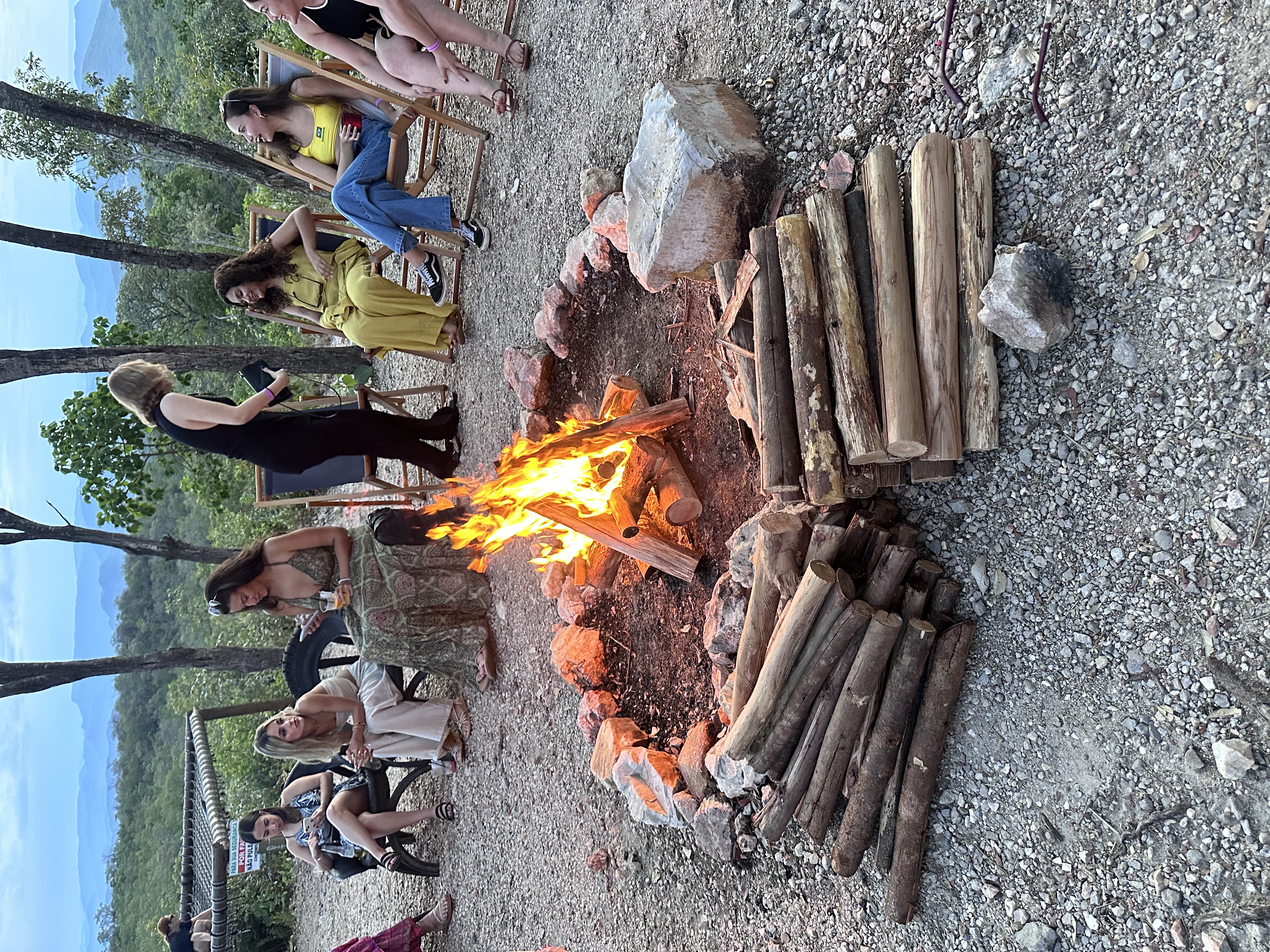 Fireplace and many girls sitting around it.