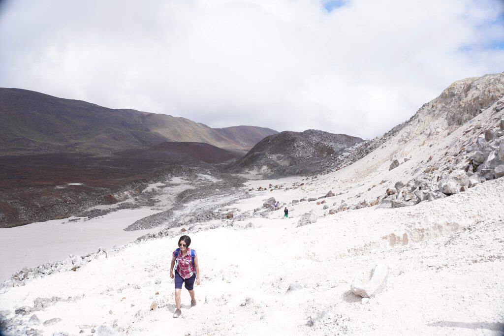 Woman walking through completely white fields inside the crater of the Sierra Negra volcano!
