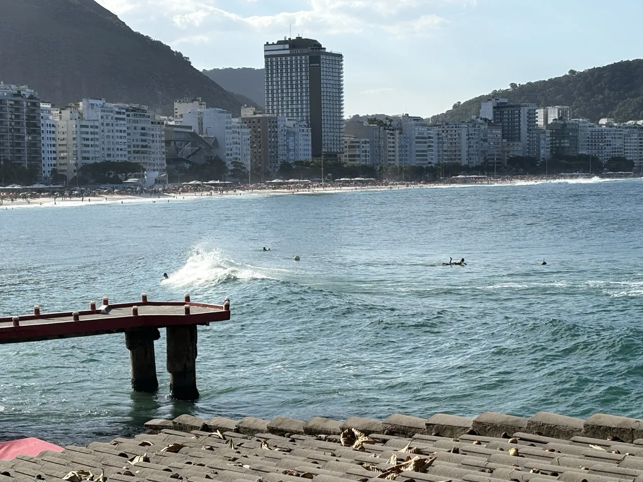 View of surfers in the ocean from Copacabana Fort on a clear day