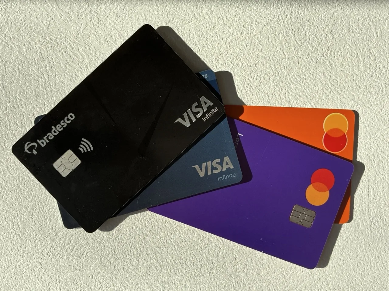 Two Visa and two Mastercard credit/debit cards piled above each other