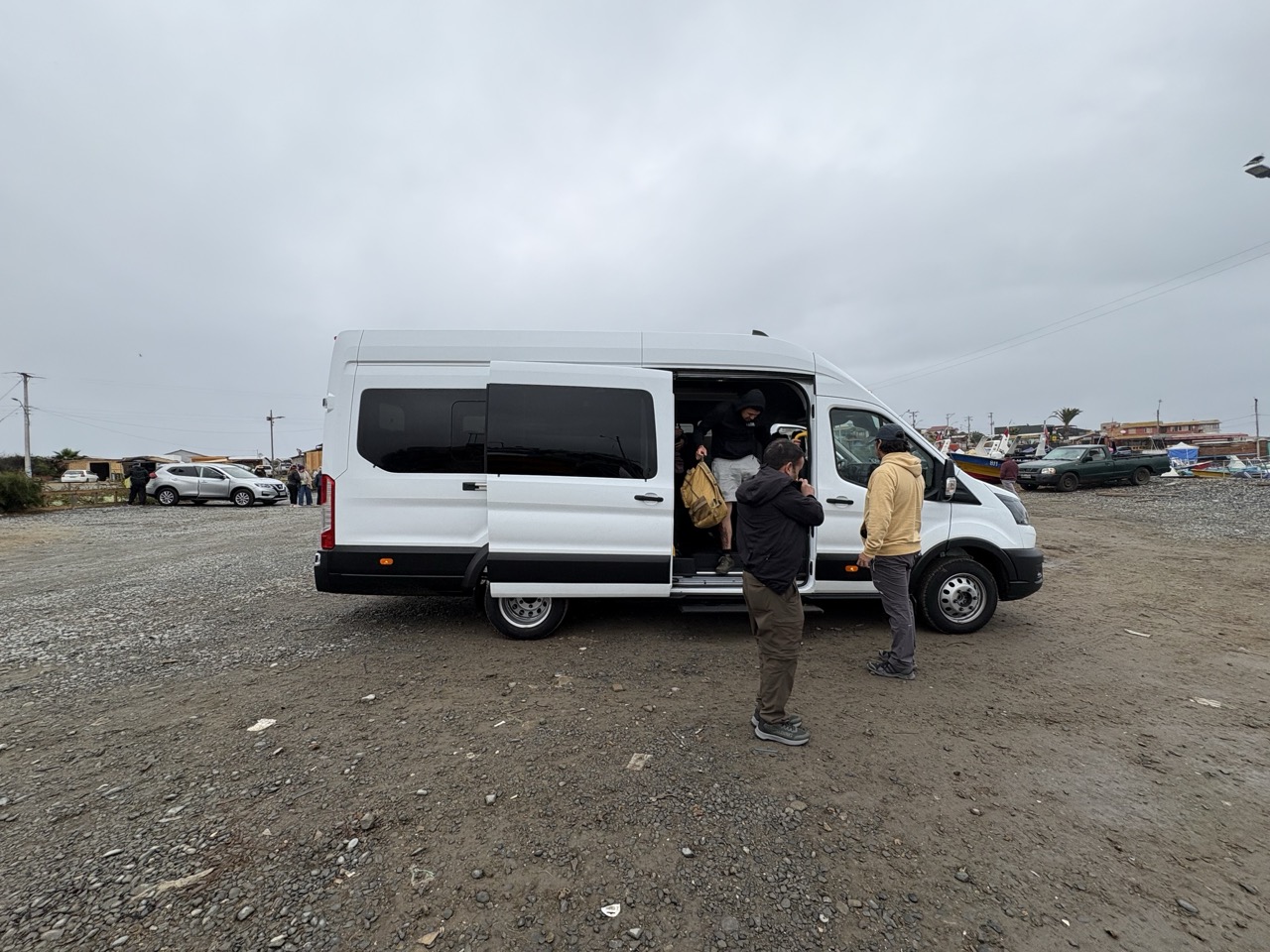 Tourists coming off a white van during the Whale Watching tour in La Serena